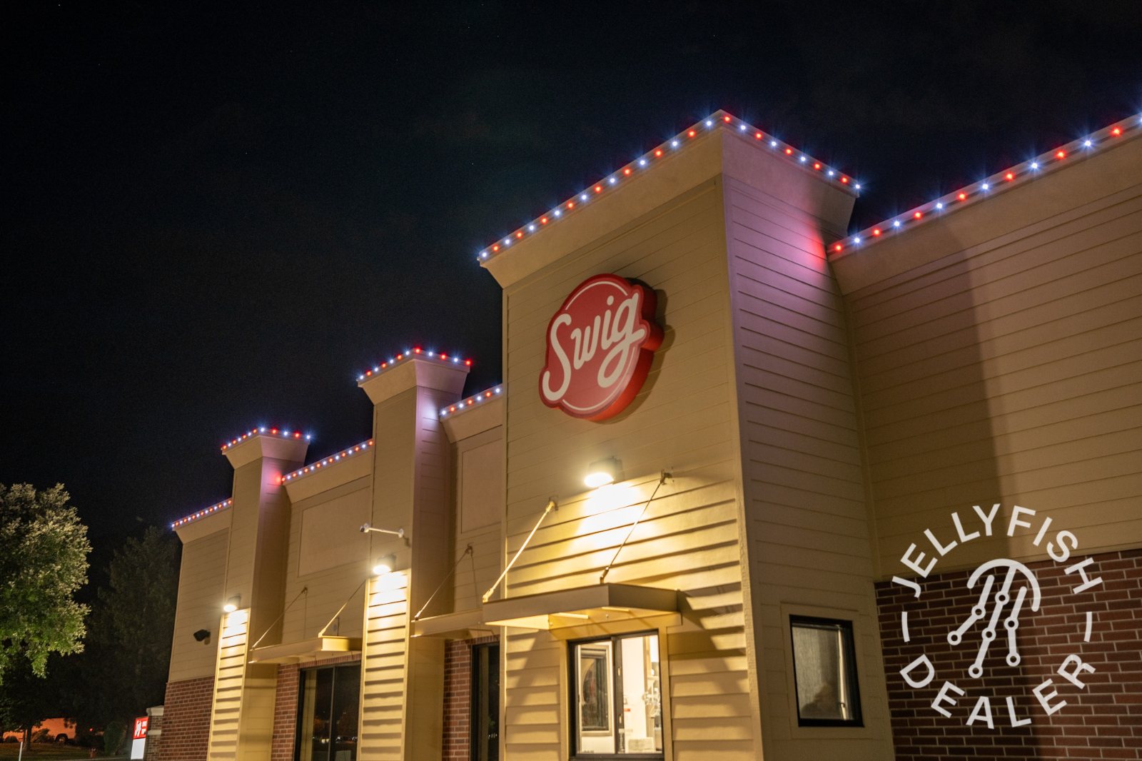 A drive-thru restaurant outlined in permanent lighting at night