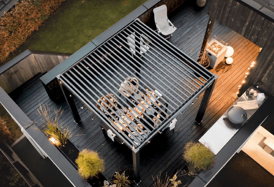 Overhead view of a louvered pergola lit at dusk